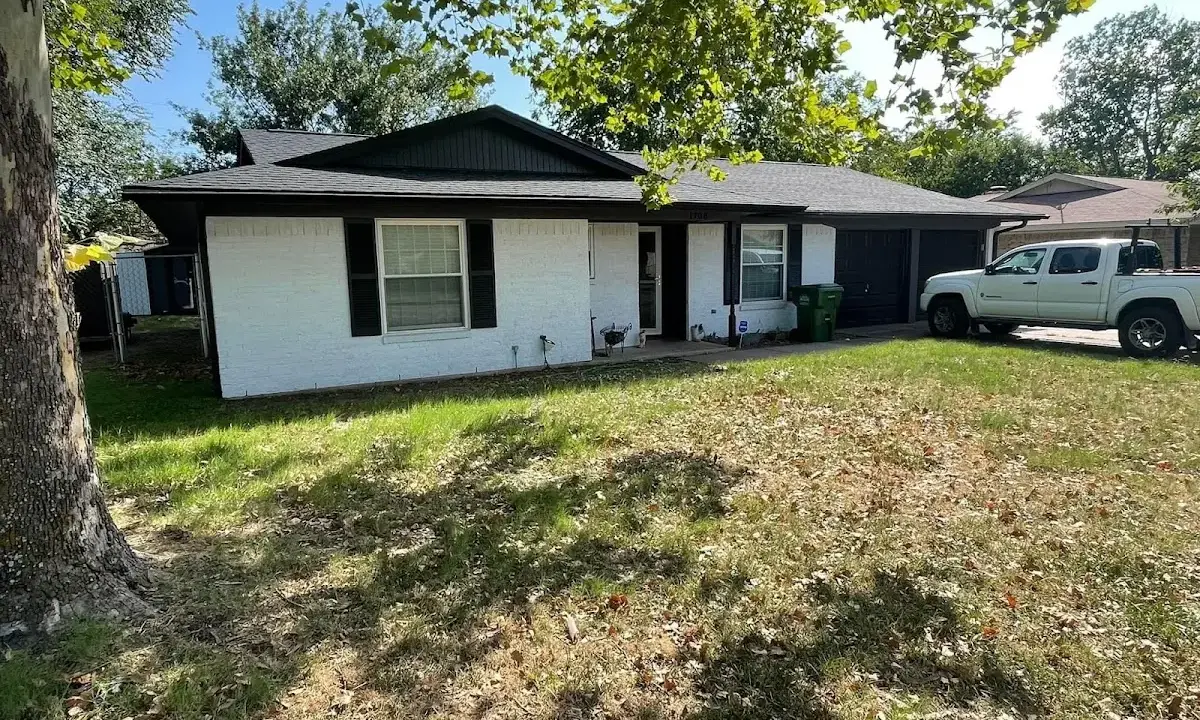 Professional roofing crew working on a residential roof in Baxter Village